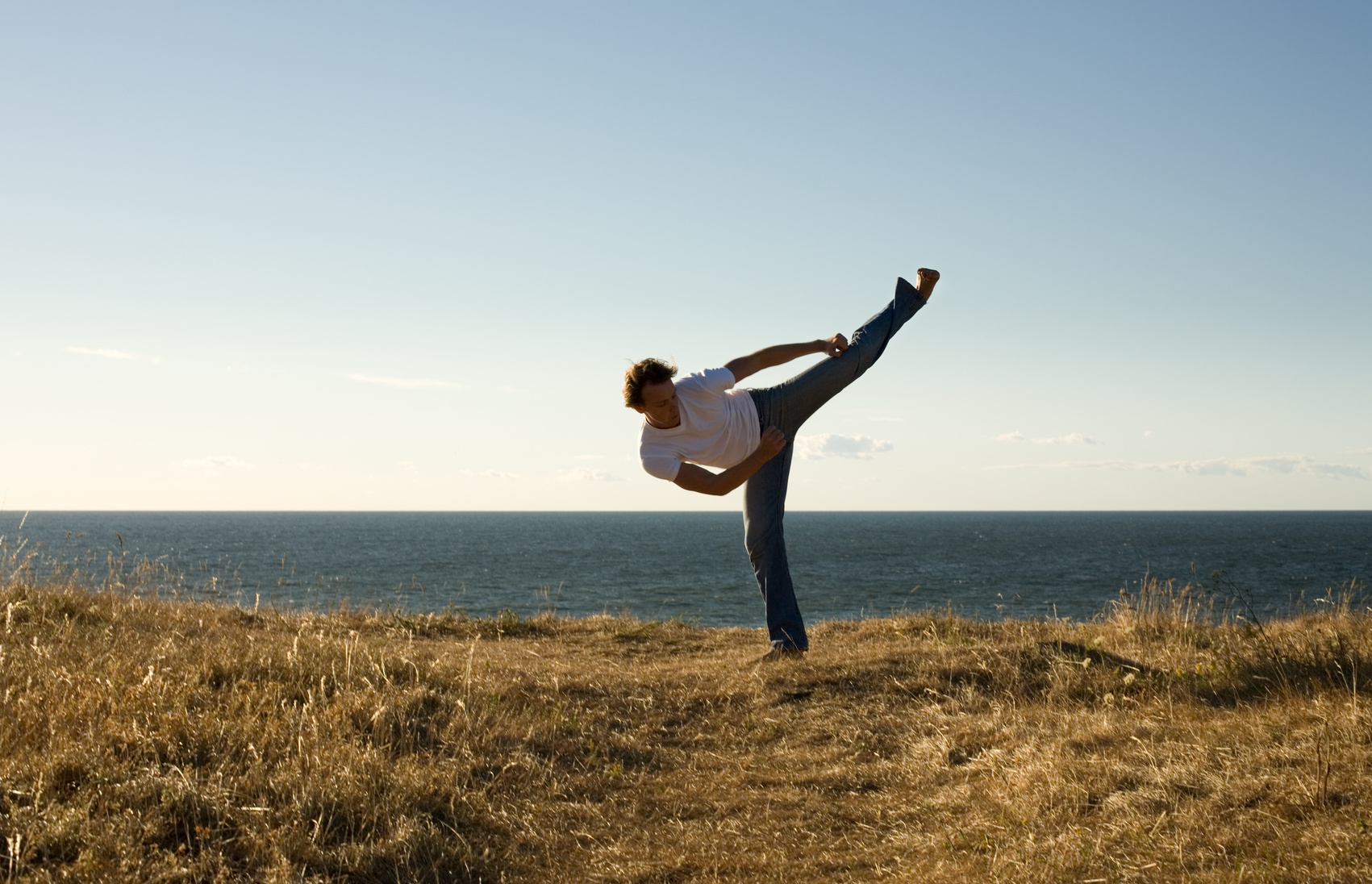 Martial Arts Master High-Kicking in the Outdoors